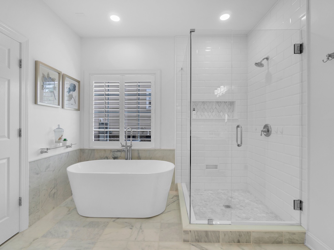 Bathroom with a freestanding tub and a glass-enclosed tiled shower